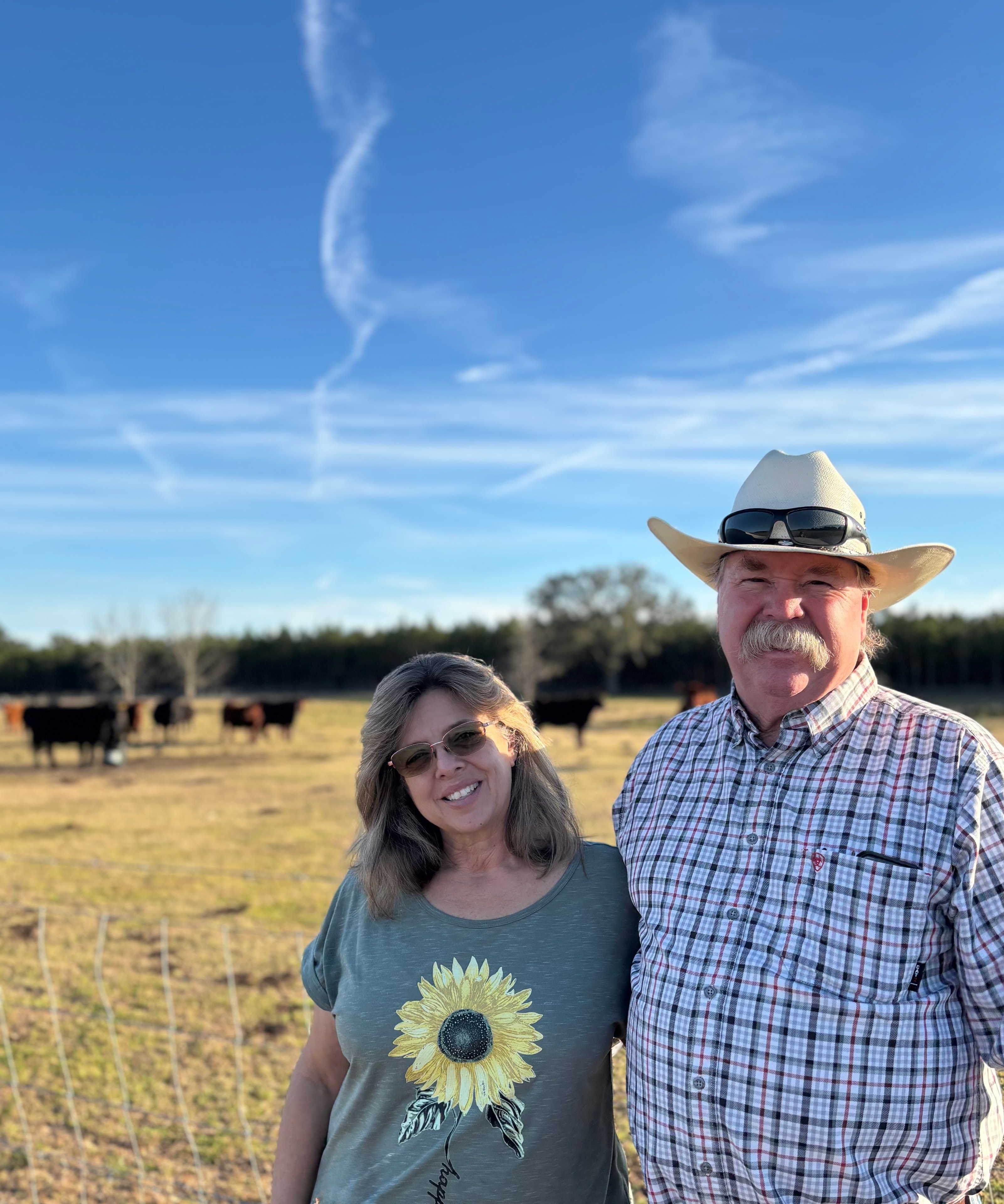 Jeff and Janet Sampson in the pasture with their cattle herd