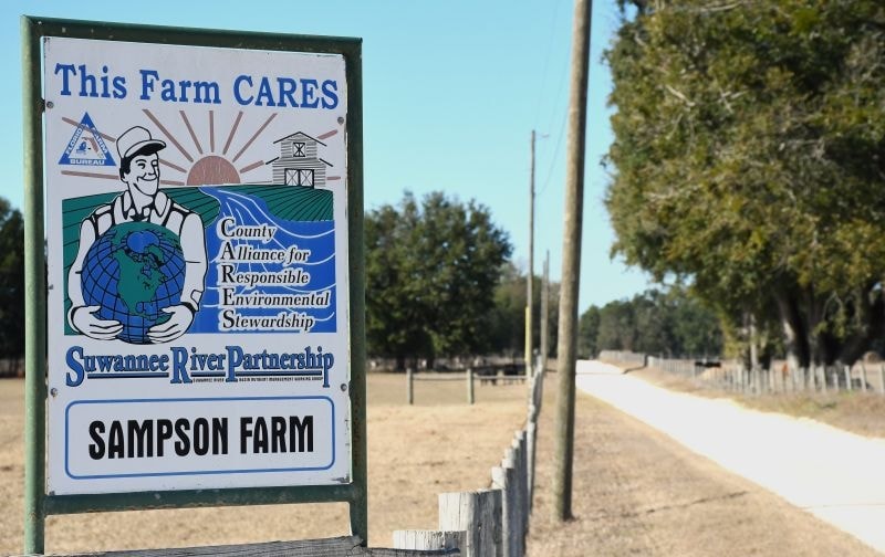 This Farm CARES Suwannee River Partnership sign at Sampson Farm