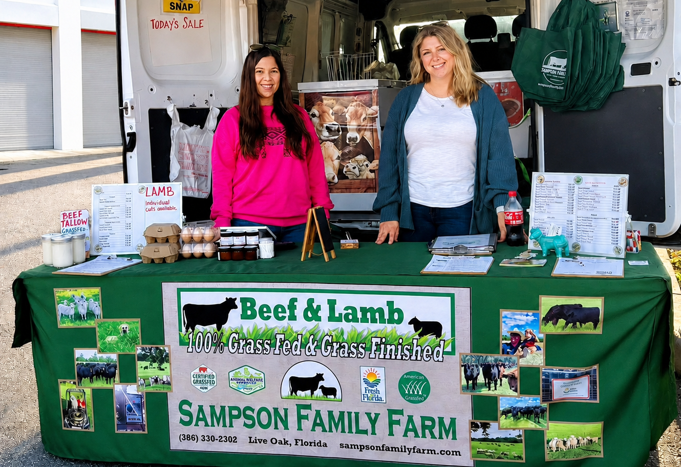 Jess and Taylor at the Sampson Family Farm farmers market booth